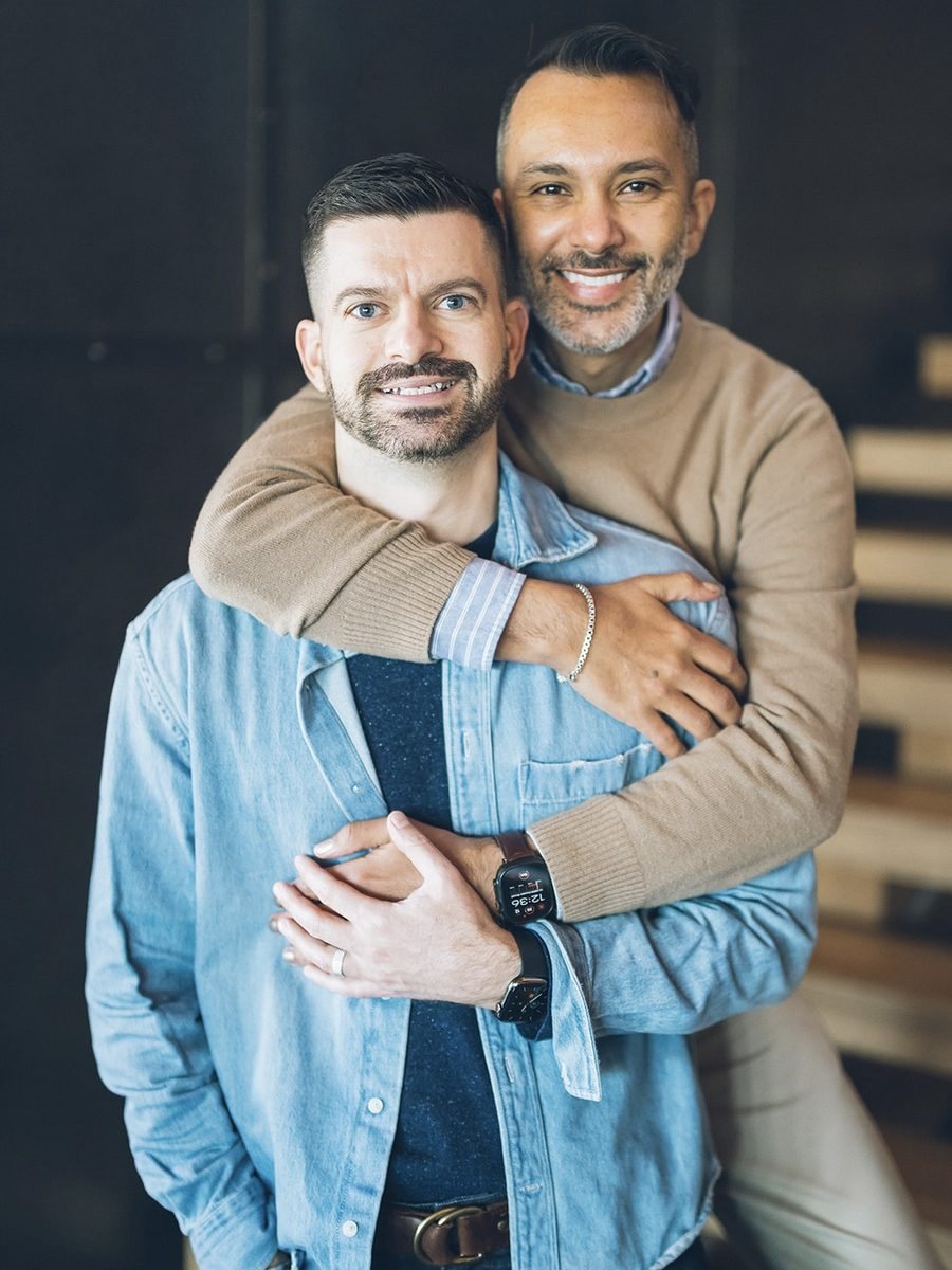 Eddie hugging Eric from behind